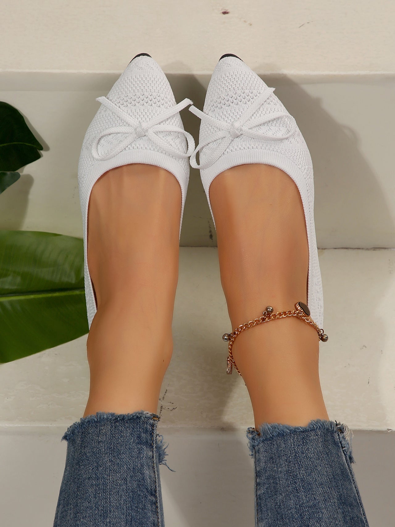 White knit pointed-toe loafers with bow and gold beaded ankle chain