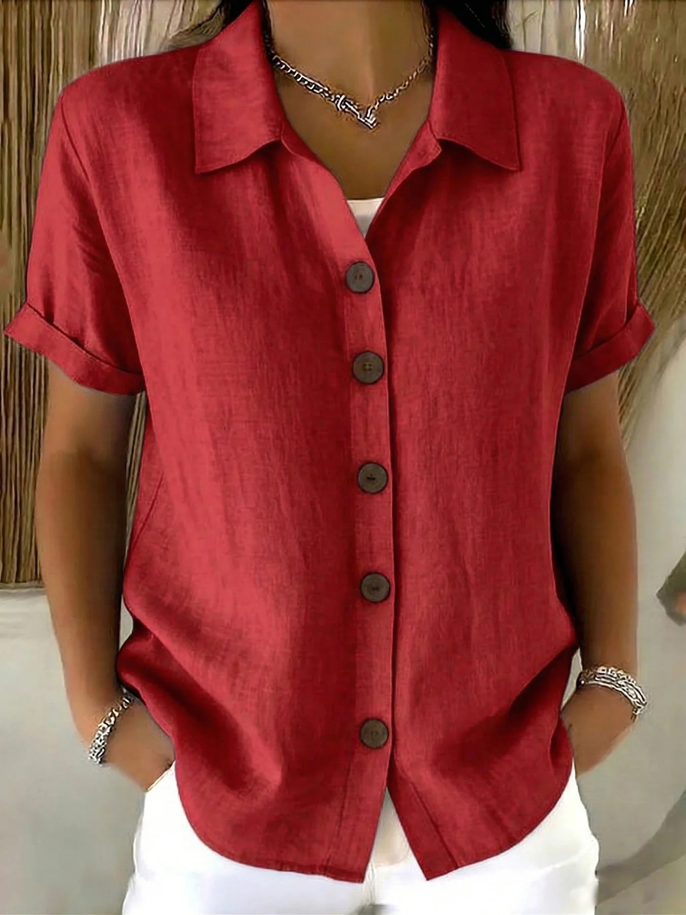 Red button-up short-sleeve shirt with front buttons and point collar