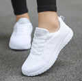 White knit lace-up sports sneakers with white laces and textured tread sole