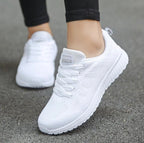 White knit lace-up sports sneakers with white laces and textured tread sole