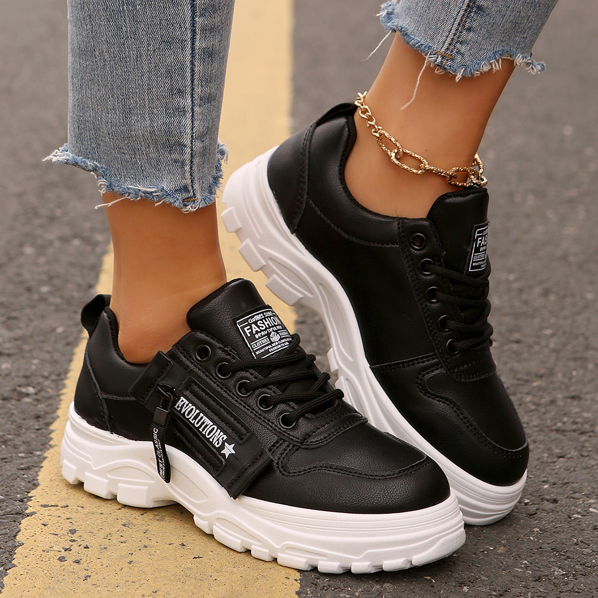Black lace-up chunky-sole sneakers with side logo patches and white rubber tread