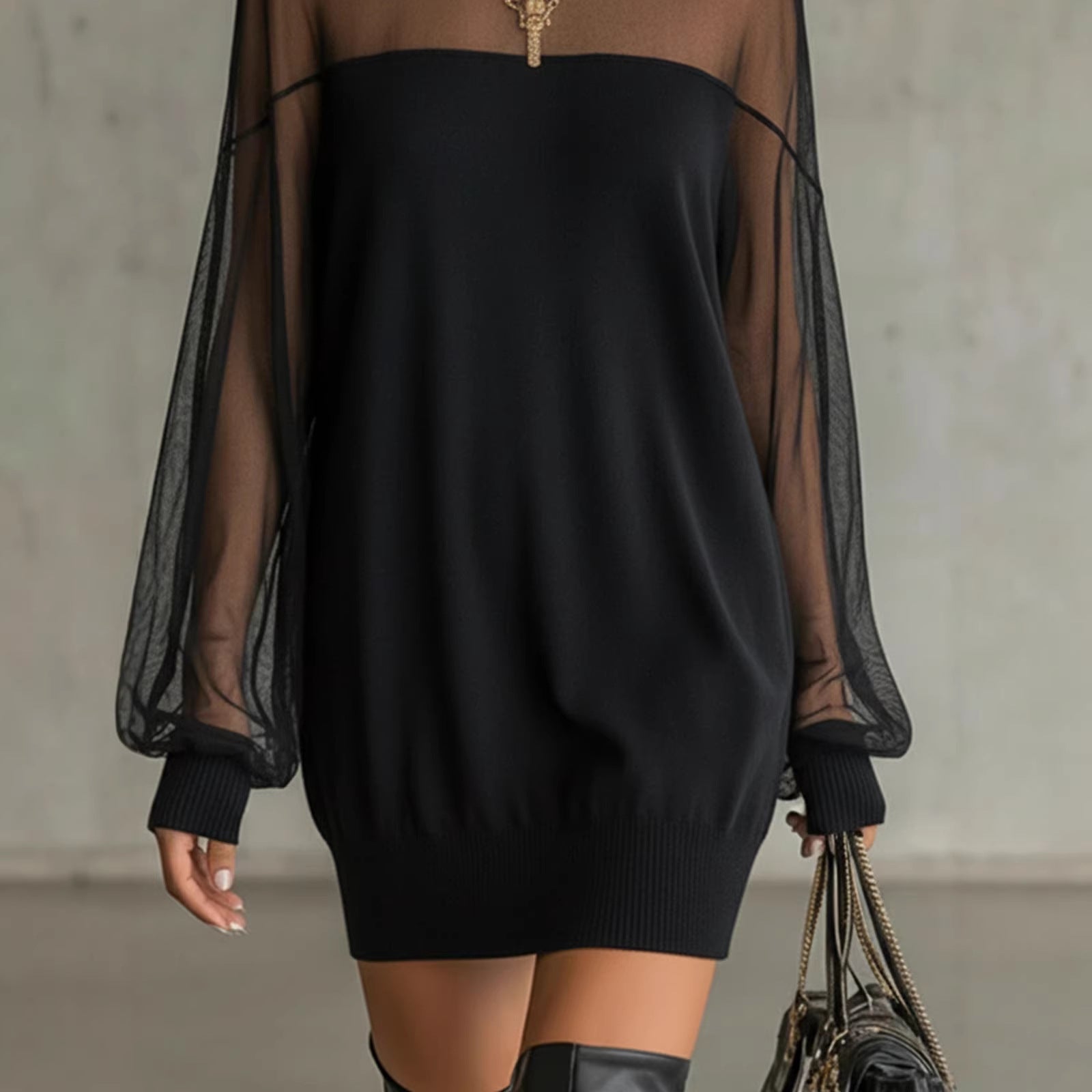 Black mini dress with sheer sleeves, ribbed cuffs, and pullover knit