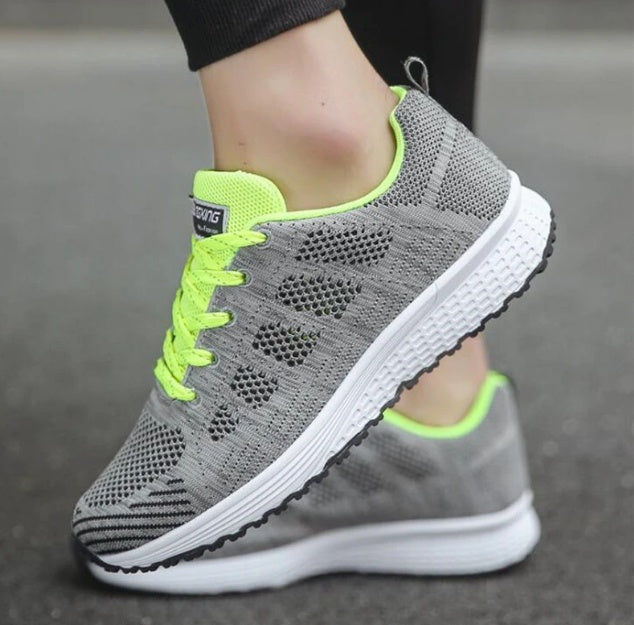 Grey knit lace-up sports sneakers with neon green laces and white tread sole