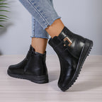 Women’s black ankle boots with buckle strap detail and chunky tread sole