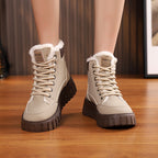 Beige lace-up ankle snow boots with sherpa lining and dark rugged tread sole