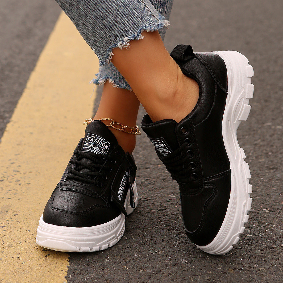 Black lace-up chunky-sole sneakers with side logo strap and molded tread sole