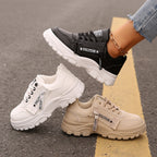 Pair of chunky-sole sneakers: black and cream lace-up with side logo strap