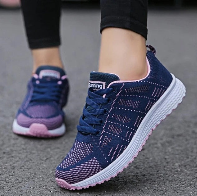 Navy knit lace-up sports sneakers with purple accents and white tread sole