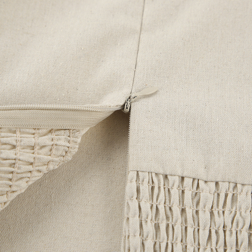 Linen fabric close-up with stitched edge and gathered trim detail