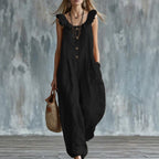 Black sleeveless button-down jumpsuit with ruffled shoulder neckline and loose leg design