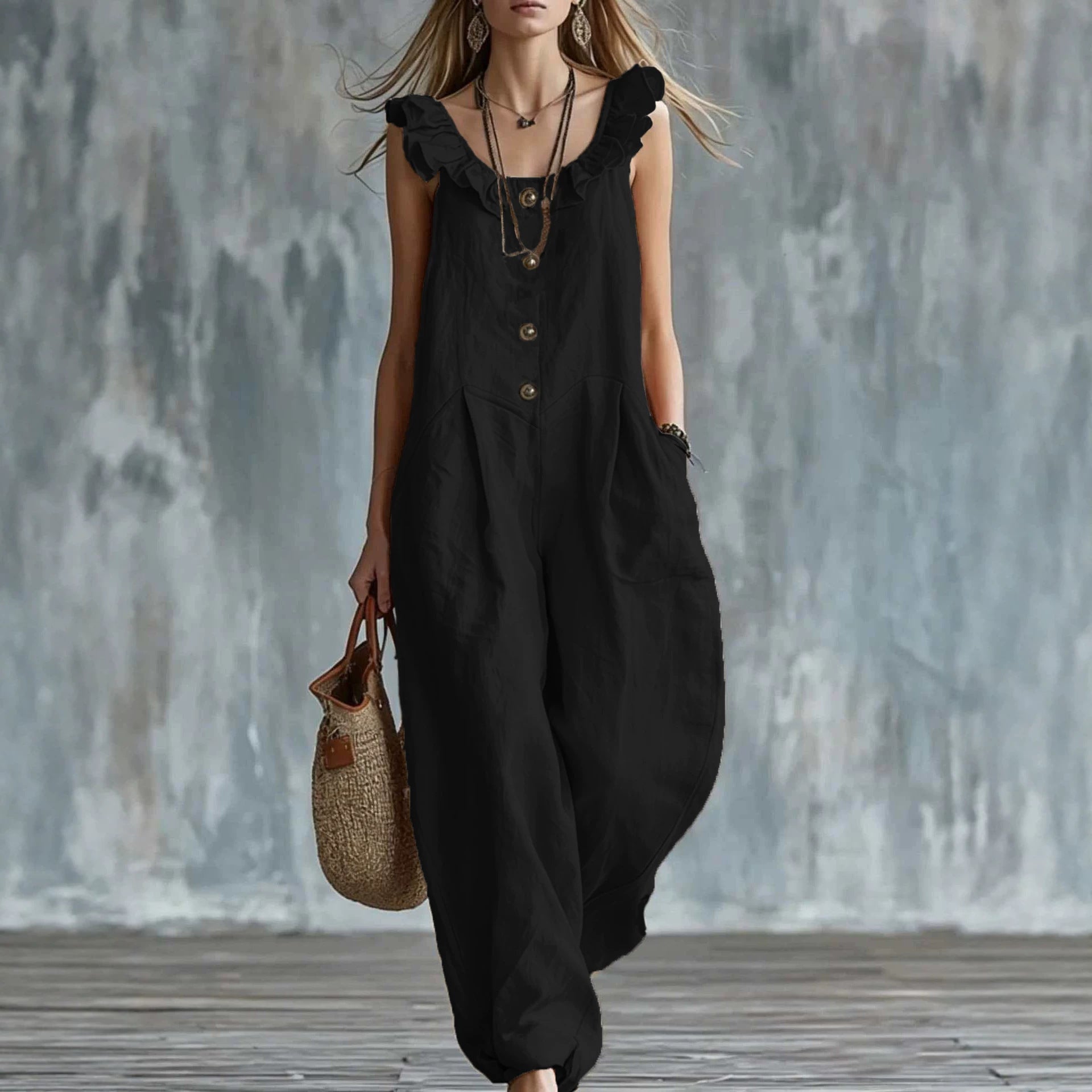 Black sleeveless button-down jumpsuit with ruffled shoulder neckline and loose leg design