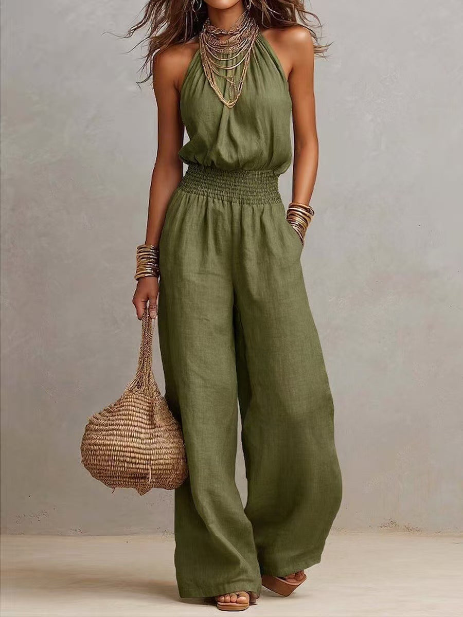 Olive green sleeveless jumpsuit with halter neck, smocked waist, and wide legs