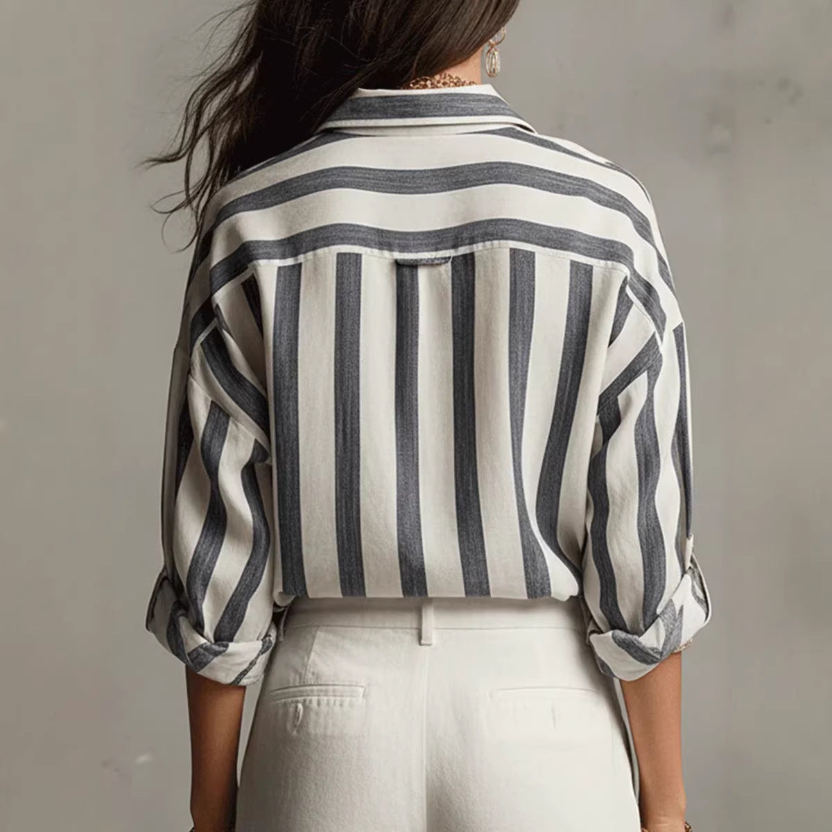 Back view: relaxed-fit collared blouse with vertical navy and white striped pattern