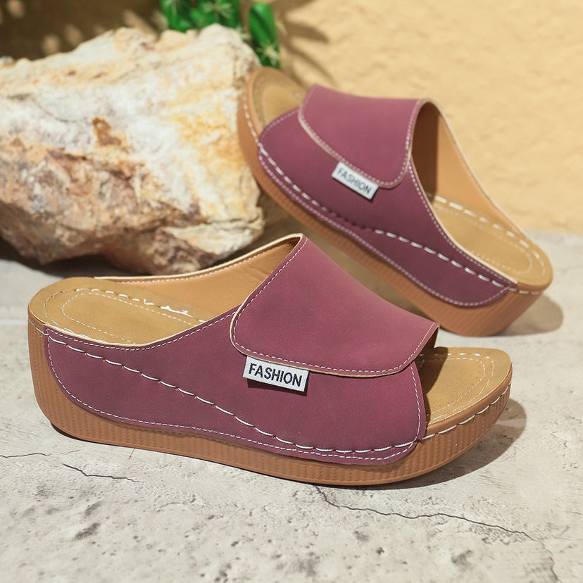 Purple wedge slide sandals with open toe cutout and white stitching detail