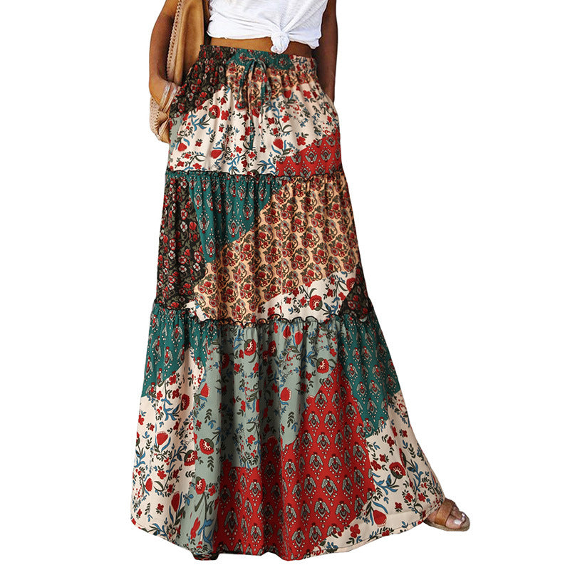 Tiered maxi dress with high waist and mixed red, cream, and green patchwork print