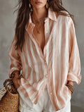 Pink and white striped oversized button-up shirt, open collar, cuffed long sleeves