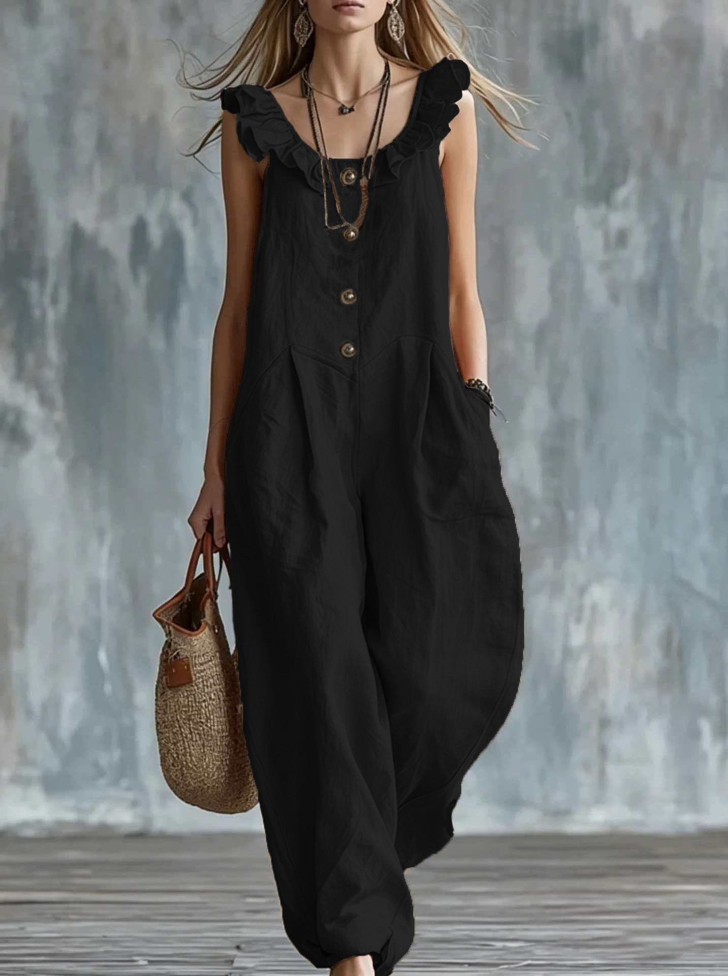 Black sleeveless button-down jumpsuit with ruffled neckline and front buttons