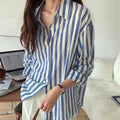 Blue and white striped long-sleeve button-up shirt, front view with buttoned placket
