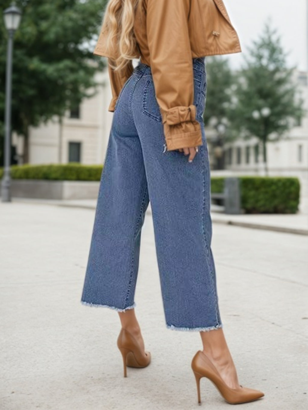 Blue high-waist wide-leg jeans with frayed cuffs and wide straight legs.