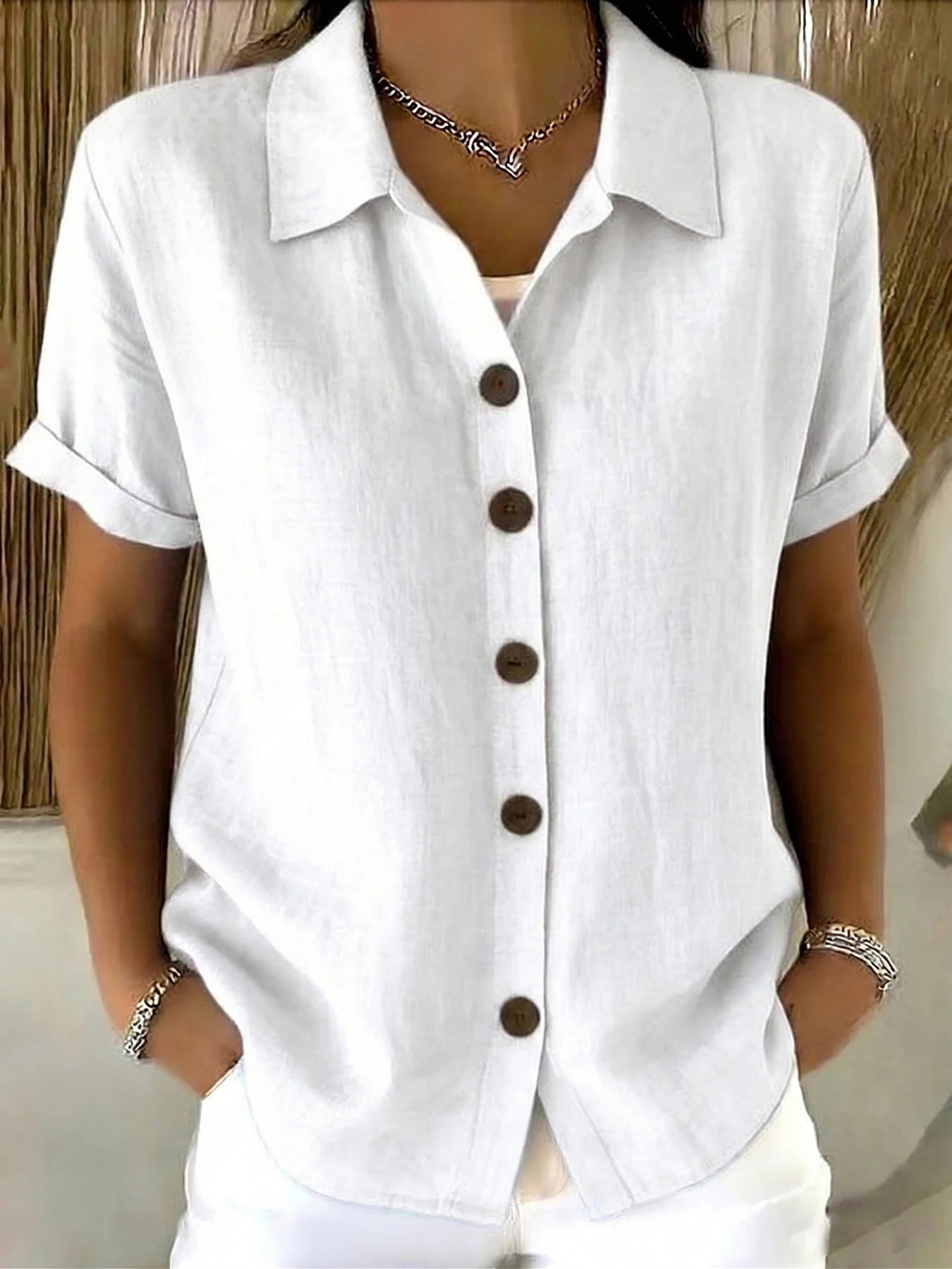 White button-up short-sleeve shirt with front buttons and point collar