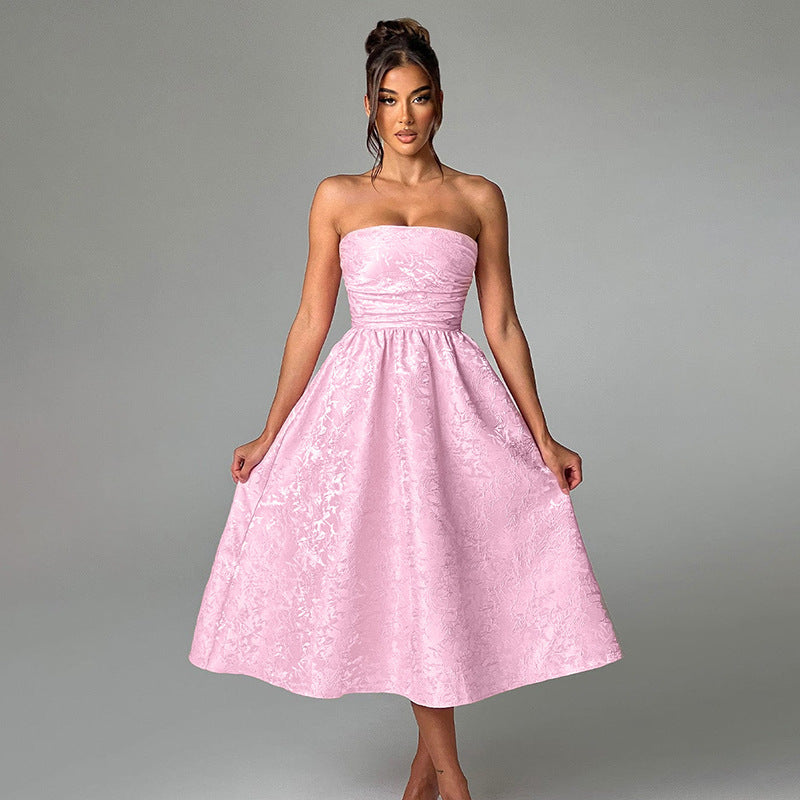 Pink satin jacquard tube top dress with fitted bodice and flared skirt.