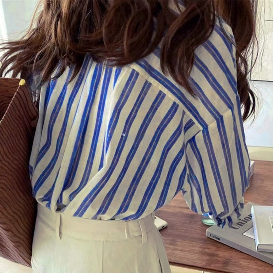 Blue and white striped long-sleeve button-up shirt, back view showing yoke and collar
