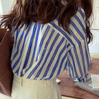 Blue and white striped long-sleeve button-up shirt, back view showing yoke and collar
