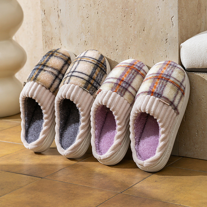 Plaid plush indoor slippers with ribbed cream trim; multicolor plaid uppers and purple and gray linings.