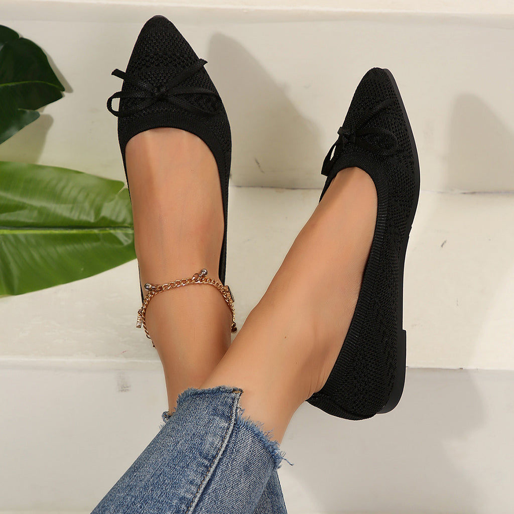 Black knit pointed-toe loafers with bow and gold beaded ankle chain