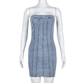 Light blue denim strapless mini dress on mannequin with vertical seam detailing and frayed hem