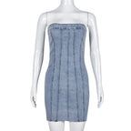 Light blue denim strapless mini dress on mannequin with vertical seam detailing and frayed hem