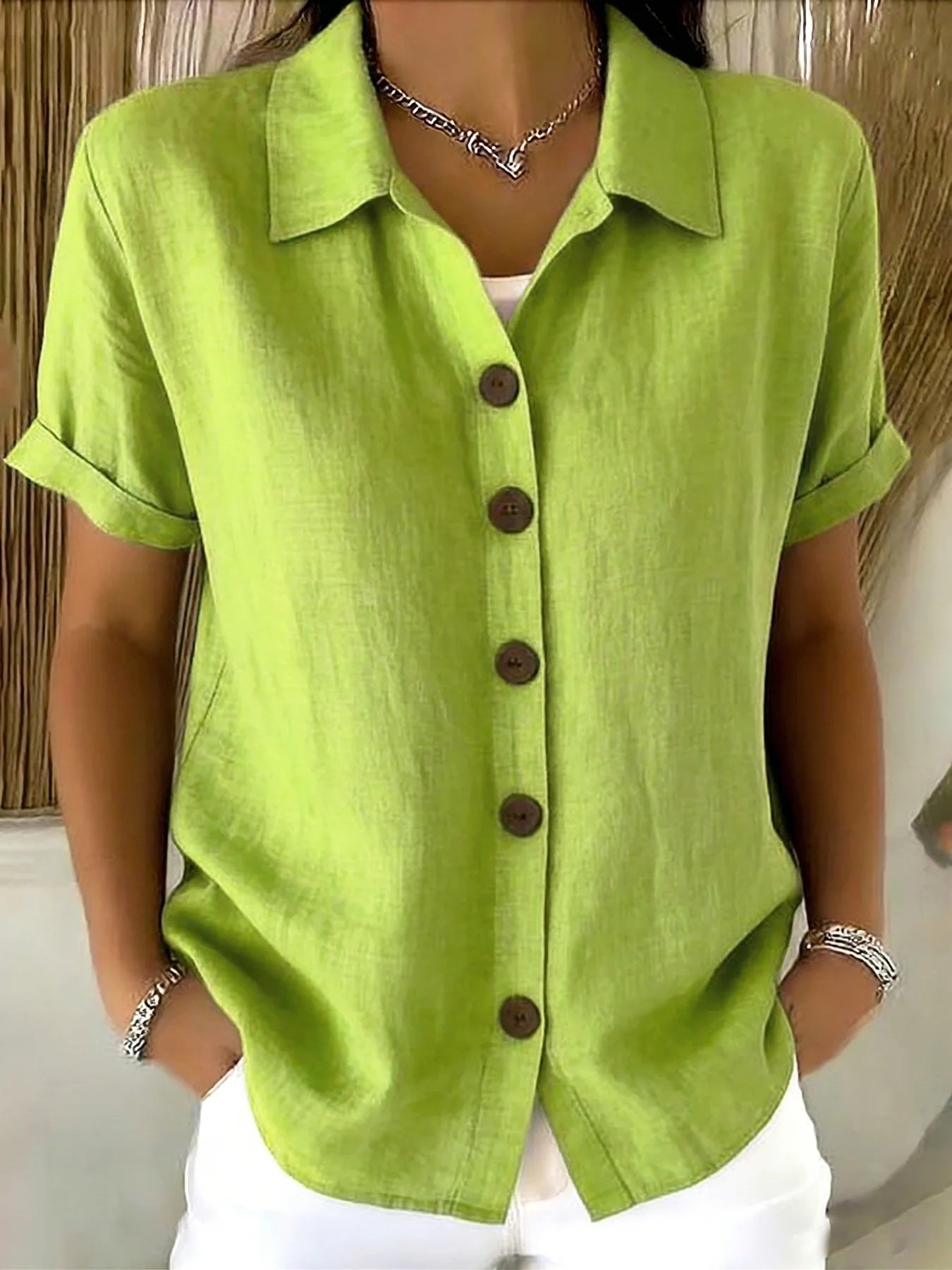 Lime green button-up short-sleeve shirt with front buttons and point collar