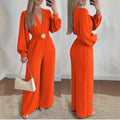 Orange deep V-neck slim-fit jumpsuit with long sleeves and waist belt