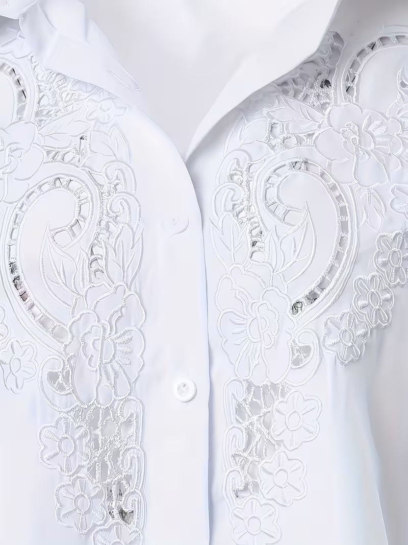 Close-up of white long-sleeve embroidered shirt front with circular floral lace panels