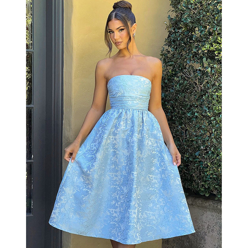 Blue satin jacquard tube top dress with ruched waist and full flared skirt.