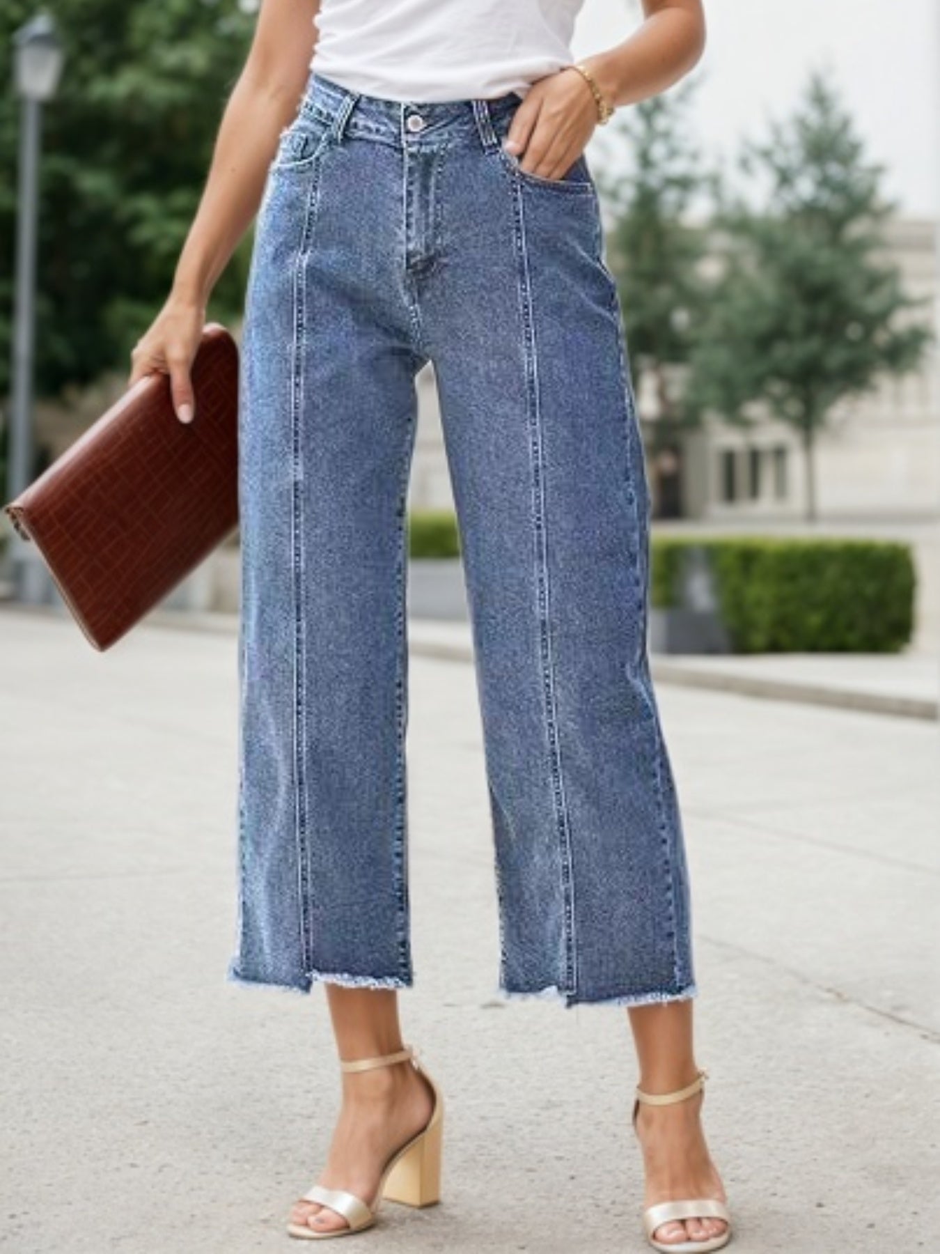 Blue high-waist wide-leg jeans with frayed straight hem, front button and belt loops.