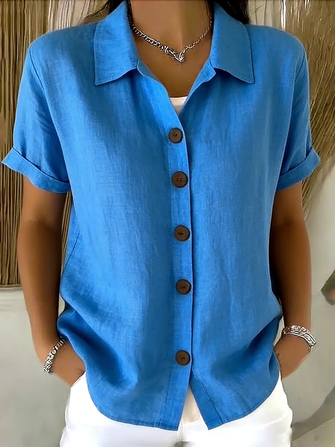 Bright blue button-up short-sleeve shirt with front buttons and point collar