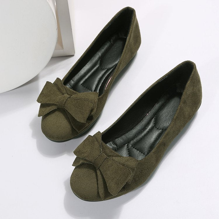 Pair of olive green suede bow comfort loafers with bow detail and rubber sole
