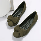 Pair of olive green suede bow comfort loafers with bow detail and rubber sole
