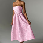 Pink satin jacquard tube top dress with ruched waist and A-line midi skirt.