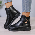 Women’s black ankle boots with side zipper, buckle hardware, and grippy sole