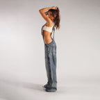Light blue denim zipper overalls with wide-leg fit, front zipper, suspender straps, pockets
