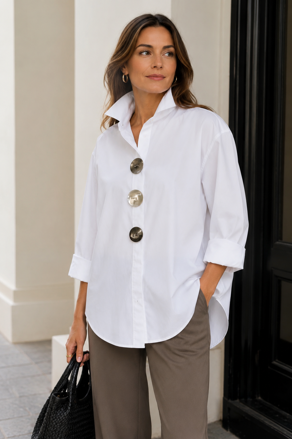 White oversized button-up shirt with pointed collar and large round statement buttons