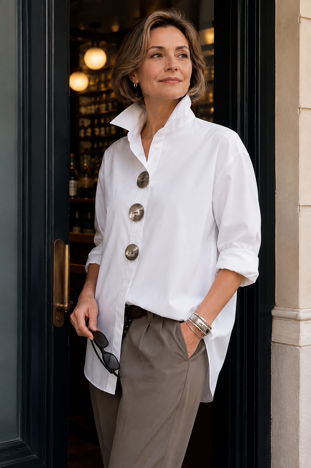 White oversized button-up shirt with pointed collar and large round front buttons, 3/4 sleeves