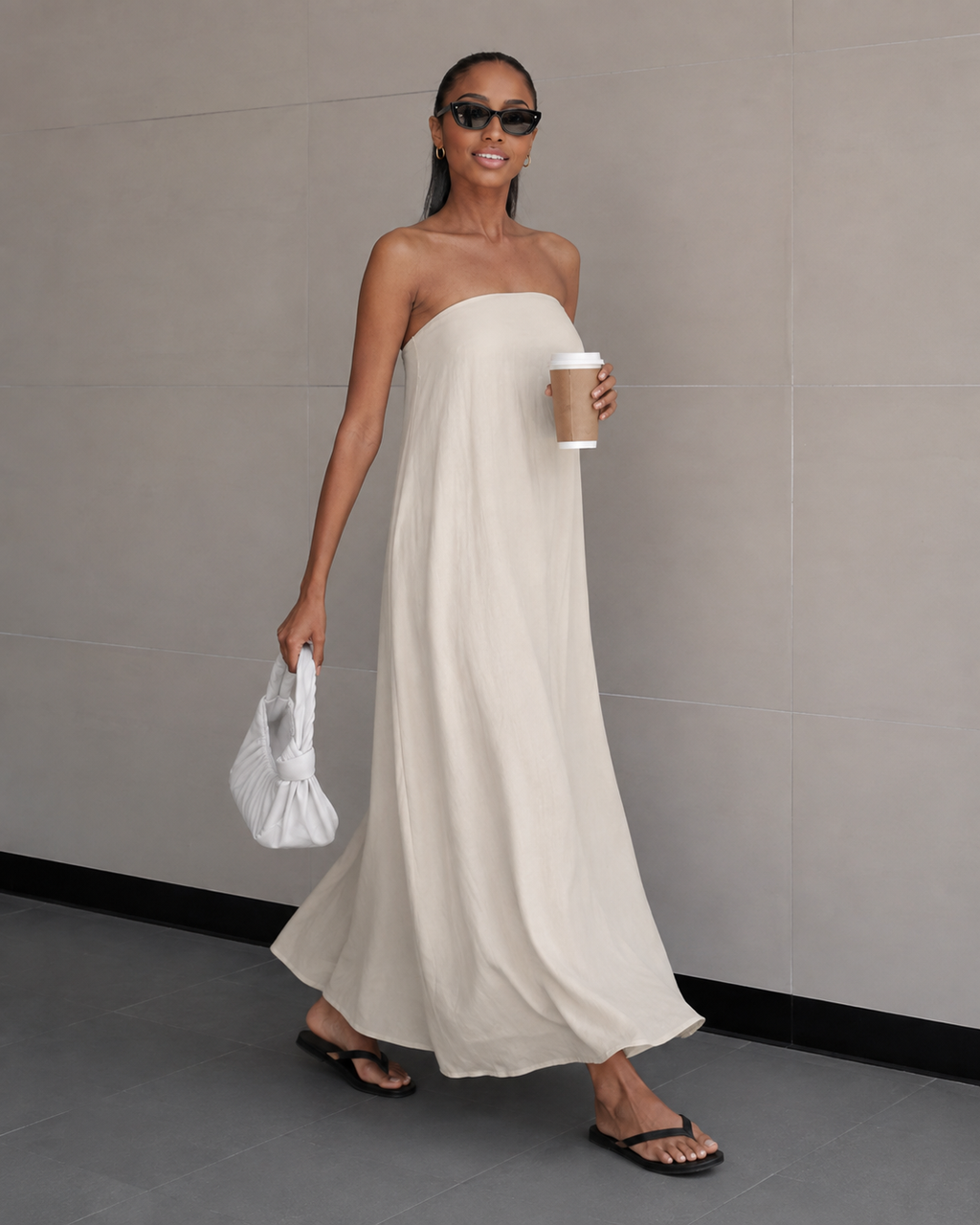 Ivory strapless maxi dress with softly draped bodice and flowing wide skirt