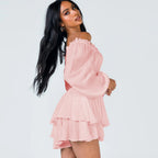 Pink off-shoulder ruffle jumpsuit with long sleeves and layered skirt tiers