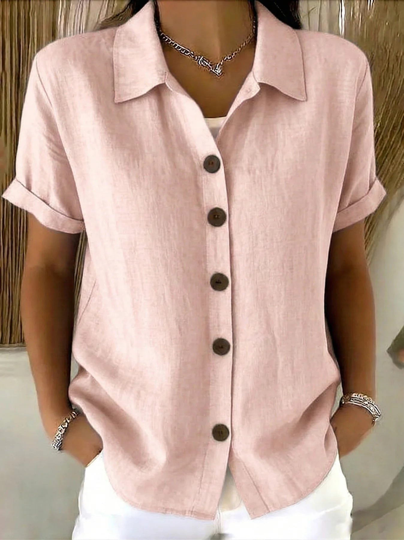 Light pink button-up short-sleeve shirt with front buttons and point collar