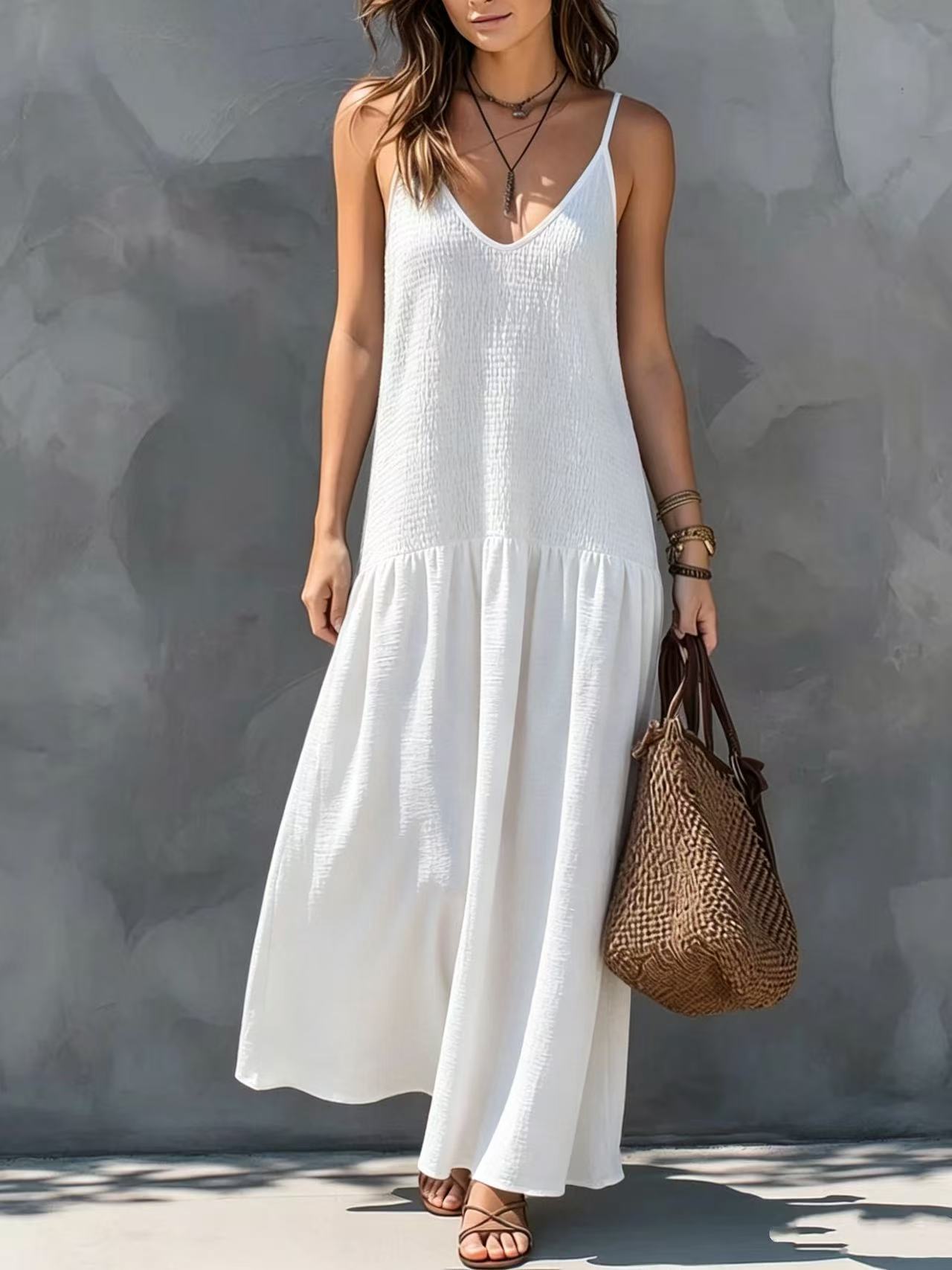 White tiered maxi dress with V-neck spaghetti straps and sleeveless bodice