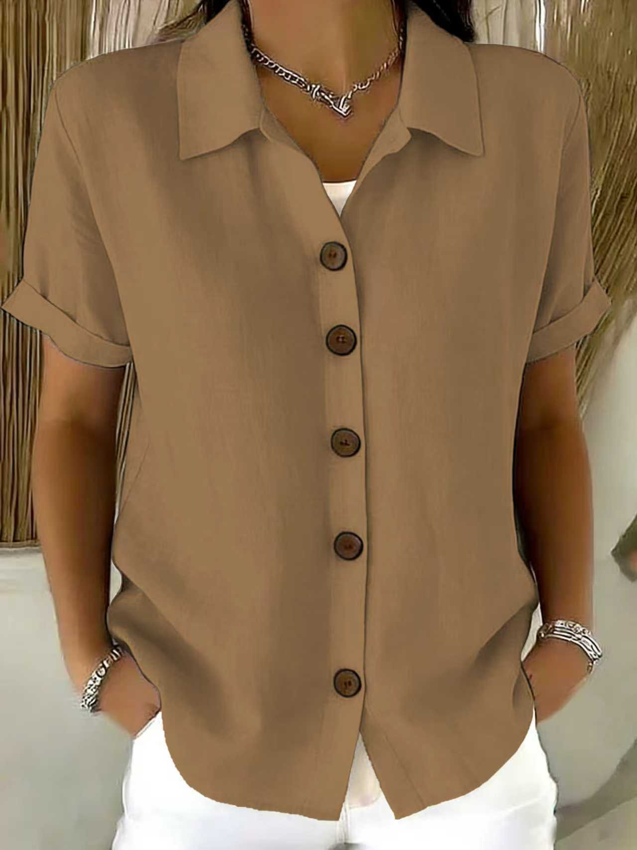 Women's collared button-front shirt in tan with short sleeves and dark buttons.