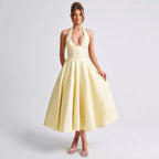 Light yellow V-neck halter sleeveless long dress with jacquard skirt and lace-up waist